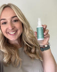 Gorgeous woman holding a bottle of Tints of Nature Structure treatment, after using the protein treatment.
